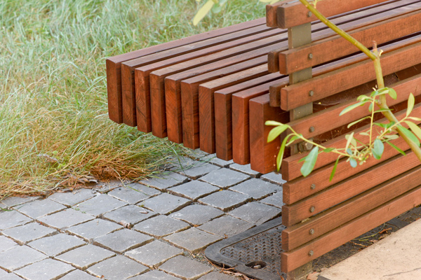 Basalt split-cube cobbles and custom redwood bench.