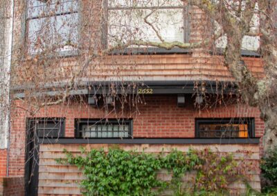 Pacific Heights Jewel: Creative brickwork fronting a 100-year-old house with custom bike shed and family heritage tree as focal point.