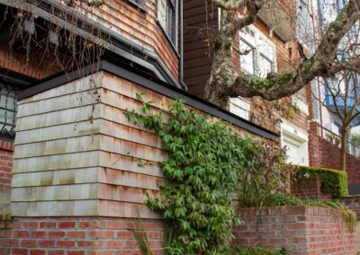 Pacific Heights Jewel: Creative brickwork fronting a 100-year-old house with custom bike shed and family heritage tree as focal point.