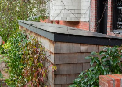 Pacific Heights Jewel: Creative brickwork fronting a 100-year-old house with custom bike shed and family heritage tree as focal point.