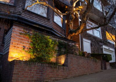 Pacific Heights Jewel: Creative brickwork fronting a 100-year-old house with custom bike shed and family heritage tree as focal point.