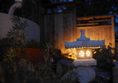 Pacific Rim Fusion: On a steep site under sandy conditions we melded Japanese aesthetics with landscape lighting and California native plants.