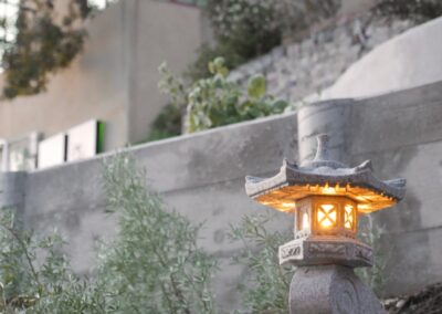 Pacific Rim Fusion: On a steep site under sandy conditions we melded Japanese aesthetics with landscape lighting and California native plants.