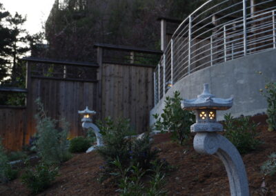 Pacific Rim Fusion: On a steep site under sandy conditions we melded Japanese aesthetics with landscape lighting and California native plants.